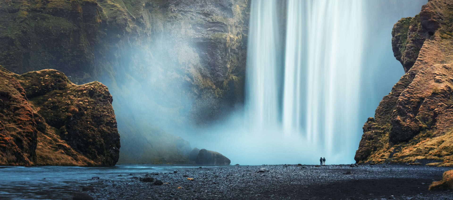 Couple of tourist near famous Skogafoss waterfall, Iceland