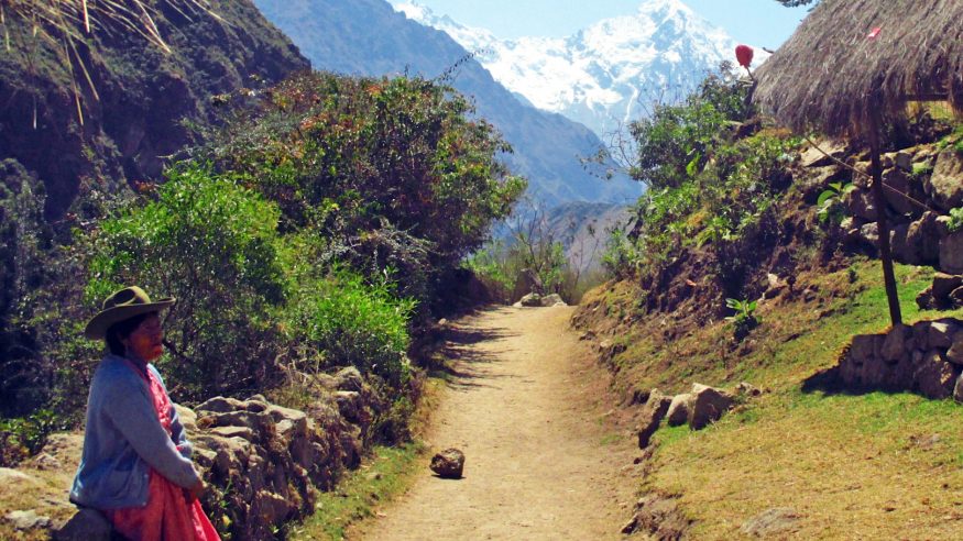 Peru_Machu-Picchu_Inca-Trail_Woman-on-trail-leading-to-snowy-mountains