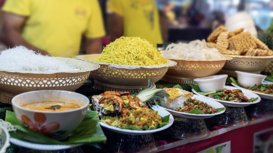thai food at the market in Phuket. noodles, tom yam soup, salads and traditional street food of Thailand on display.