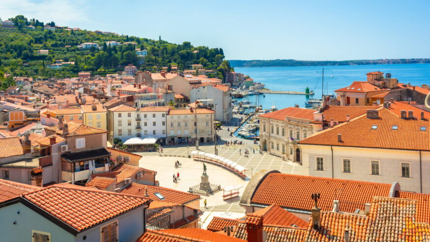 Aerial view of tartini square, the heart of piran, with its venetian architecture, overlooking the adriatic sea on a sunny summer day