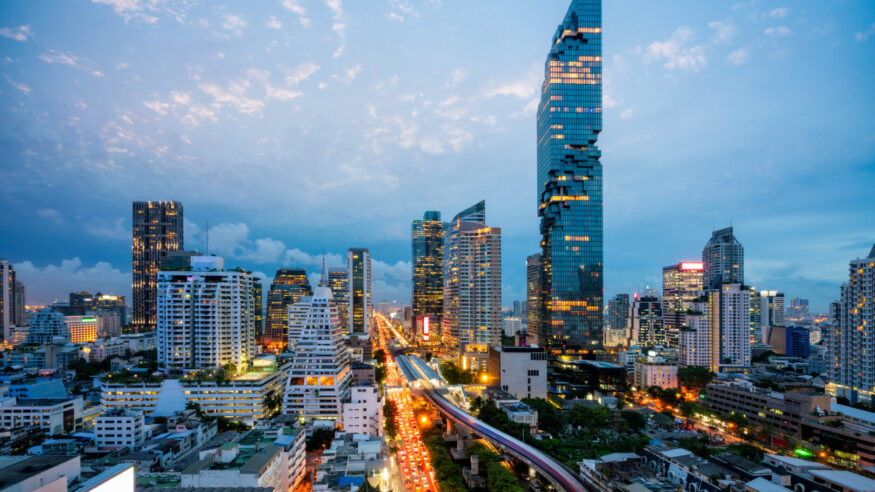 Aerial view of Bangkok skyline and skyscraper with BTS skytrain Bangkok downtown. Panorama of Sathorn and Silom business district Bangkok Thailand at night.