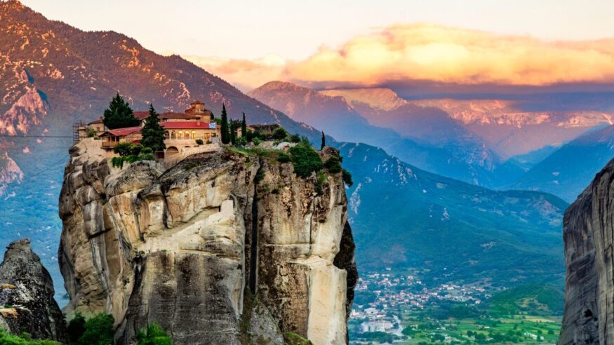 Panoramic view of Meteora mountain and religios monastery of Greece illuminated in sunset light