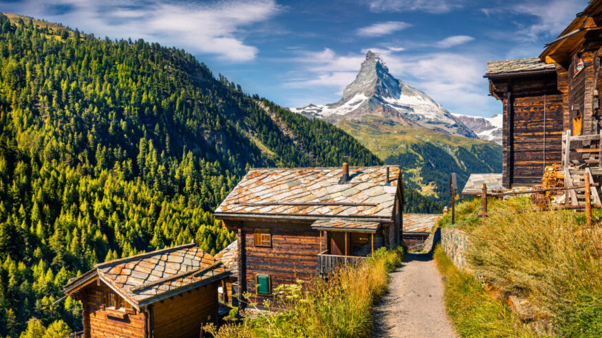 Sunny summer morning in Zermatt village with Matterhorn (Monte Cervino, Mont Cervin) peak on backgroud. Beautiful outdoor scene in  Swiss Alps, Valais canton, Switzerland, Europe.
